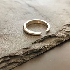 Discover the beauty of simplicity with our stunning Silver Minimalist Design Ring. Crafted with precision and elegance, this open-design ring embodies modern chic. Its versatile style allows you to wear it with the opening facing up or down, offering you two distinct looks in one piece. Made from high-quality sterling silver, this ring is not only a statement of understated luxury but also a versatile accessory that complements any outfit. Whether you're dressing up for an evening event or addin Minimalist Sterling Silver Rings With Polished Finish, Minimalist White Gold Stackable Rings With Polished Finish, Modern Rings With Simple Design And Open Band, Modern Open Band Rings With Simple Design, Minimalist White Gold Open Band Jewelry, Minimalist Open Circle Jewelry With Simple Design, Modern Open Band Ring With Simple Design, Minimalist Crescent Jewelry For Anniversary, Adjustable Open Ring Minimalist Style