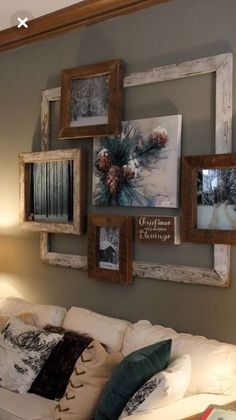 a living room filled with furniture and framed pictures on the wall above it's couch