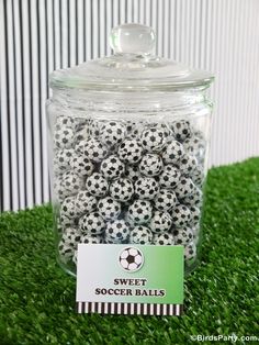 soccer balls in a jar on the grass with a name tag for sweet soccer balls