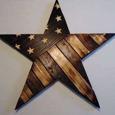 a wooden star with stars painted on the side and wood planks in the middle