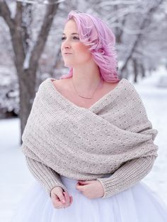 a woman with pink hair wearing a sweater and tutu skirt standing in the snow