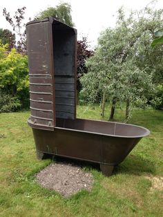 an old fashioned bathtub sitting in the grass