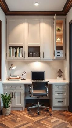 a home office with white cabinets and wood floors