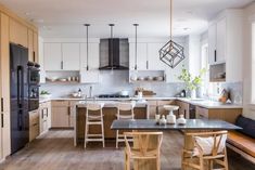 a kitchen filled with lots of wooden furniture