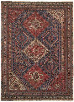 an antique persian rug with red, blue and beige colors on the center square area