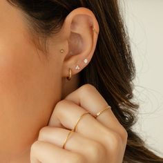 Say hello to your new favorite earring pairs with the Signature Earrings Set #2! You'll love how versatile these earrings are. Whether it's the Dainty CZ Stud Earrings, the Triple CZ Stud Earrings, or Huggie Hoop Earrings, any pair you pick will add a beautiful shine to your outfit. They're lightweight yet durable, so you can wear them all day - and every day! DETAILS Set includes three pairs of earrings: Huggie Hoop Earrings 14k gold vermeil -or- sterling silver huggie hoops 12mm diameter; 2mm 3 Earring Set, Ear Piercings 3 Holes, Triple Piercing Earrings, Love Knot Ring, Solid Gold Bracelet, Piercing Earrings, Diamond Jewelry Necklace, Solid Gold Necklace, Gold Bead Bracelets