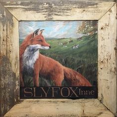 an old wooden frame with a painting of a fox on it's side and the words slyfox time