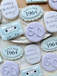 cookies decorated to look like old school music cassettes and the words vintage 1960 on them