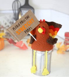 a crocheted turkey hat sitting on top of a tin can