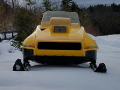 a yellow car is parked in the snow