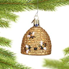 a christmas ornament hanging from a pine tree with two bees on the inside