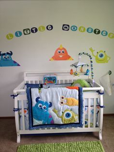 a baby crib with monsters on the wall