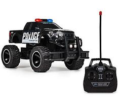 a remote control police truck is shown with its lights on and radio attached to it