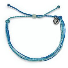 Wear this bracelet of ocean blues to feel the Pura Vida vibes. Each Good Vibes classic bracelet is handmade from waxed string cording, waterproof and totally unique. The more you wear it, the cooler it looks. The bracelet encourages the Pura Vida vibe, a philosophy to live life to the fullest. Pura Vida provides sustainable jobs to artisans worldwide who are dedicated to the "pura vida" way of life. | Pura Vida Original string bracelet in Deep Dive design. | Wax-coated polyester string cord with Puts Vida Bracelets, Adjustable Blue Ocean-inspired Friendship Bracelets, Blue Adjustable Cord Jewelry For Vacation, Blue Jewelry With Adjustable Cord For Vacation, Adjustable Blue Friendship Bracelets For Vacation, Trendy Waxed Cord Jewelry For The Beach, Trendy Waxed Cord Braided Bracelet For Beach, Casual Turquoise Braided Bracelet With Sliding Knot, Trendy Blue Braided Bracelets For Vacation