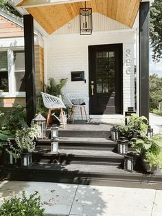 the front porch is clean and ready for us to use as an outdoor space with potted plants