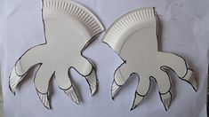 two paper plates shaped like squids on a white background