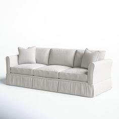 a white couch sitting on top of a white floor