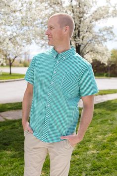 Unleash your vibrant style with the Mens James Shirt in Green Gingham! Featuring a classic button up design with a sharp collar and short sleeves, this shirt will keep you looking sharp and stylish. The white and green gingham print adds a touch of sophistication, while the front pocket provides functional convenience. Don't forget the matching styles for the whole family. Casual Collared Gingham Shirt, Casual Gingham Collared Shirt, Classic Green Collared Short Sleeve Shirt, Classic Green Short Sleeve Shirt, Classic Plaid Short Sleeve Shirt For Summer, Green Cotton Short Sleeve Shirt For Spring, Fitted Green Button-up Short Sleeve Shirt, Spring Plaid Short Sleeve Shirt, Green Casual Top For Picnic