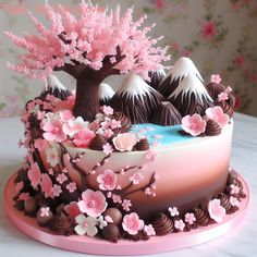 the cake is decorated with pink flowers and chocolate trees on it's side,