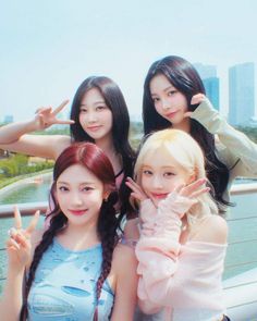 three girls posing for the camera with their fingers in the air