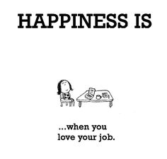 a person sitting at a table with a book in front of them that says happiness is when you love your job