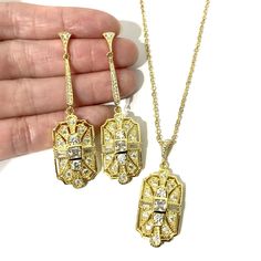 "A 1920s vintage style bridal jewelry set featuring Art Deco Gatsby wedding necklace and geometric dangle cz earrings on sterling silver posts, made of sparkly clear cubic zirconia with silver rhodium white or yellow or rose gold plated bail and chain. Earrings are about 2 1/4\" (5.7cm) with sterling silver posts. Pendant is 1 5/8\" (4.3cm) long with bail. Chain length can be added with a 2\" extender chain. Matching brooch pin at https://etsy.me/2Wk6HzE View matching pieces or similar designs a Art Deco Hallmarked Jewelry For Wedding, Art Deco Hallmarked Wedding Jewelry, Art Deco Sterling Silver Jewelry For Wedding, Sterling Silver Art Deco Jewelry For Wedding, Art Deco Jewelry With Diamond Accents For Evening, Art Deco Diamond Accented Jewelry For Wedding, Art Deco Diamond Cut Earrings For Wedding, Art Deco Wedding Jewelry With Diamond Accents, Art Deco Diamond Cut Wedding Earrings