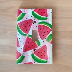 a light switch cover with watermelon slices on it