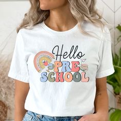 If you're a preschool teacher, this "Hello Preschool" shirt is perfect for you! Colorful and bright, this is a perfect tee to welcome your student to preschool! Shirts For Teachers Ideas, Cute Multicolor T-shirt For Back To School, Cute T-shirt For Teacher Appreciation Back To School, Cute T-shirt For Back To School Teacher Appreciation, Playful T-shirt For Daycare And Back To School, Preschool Shirts For Teachers, Shirts For Teachers, Cute Teacher Outfits, Preschool Shirts