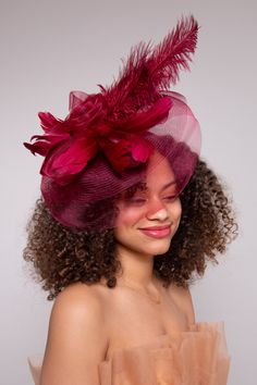 Absolutely breathtaking! With its large floral design and eye-catching peacock feathers, the Iconic Style Fascinator is also embellished with faux feathers, a crinoline floral bloom, and delicate netting. This exudes glamour and sophistication! NO RETURNS/EXCHANGES due to the nature of the product (special occasions and headwear). Not all screens/lighting are created equal. Make sure you are happy with the color match before ordering! If you have any concerns, let us know! Detachable Headband In Elegant Tulle Fascinator, Red Feathered Mini Hat For Evening, Red Mini Hats With Feather Trim For Party, Red Feather Headpiece For Kentucky Derby, Red Feathered Headpiece For Kentucky Derby, Red Evening Mini Hat With Feathers, Red Feathered Fascinator For Formal Occasions, Red Feathered Fascinator For Kentucky Derby, Red Feathered Fascinator For Wedding