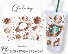 the starbucks cup has gold foil on it and is next to an advertisement for galaxy