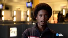 a young man is standing in an airport