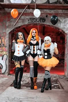 three women dressed up in costumes posing for the camera with balloons floating above their heads