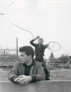 an old photo of two people with tennis rackets