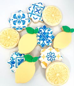 decorated cookies in the shape of lemons and grapefruits on white background