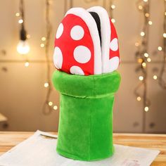 a green hat with white polka dots on it sitting on top of a wooden table