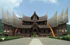 a large wooden building with many flags on it's roof