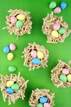 four birds nest cupcakes with chocolate frosting and candy eggs in the middle