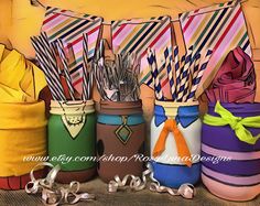 there are many different colored mason jars with ties on them