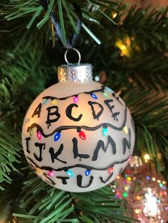 a christmas ornament with the letters abcd and kln on it