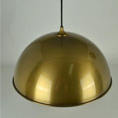 a gold colored light hanging from a ceiling