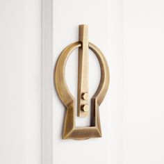 a door handle on the side of a white door with a black and gold design