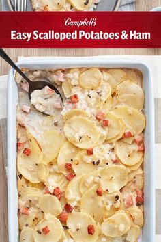 a casserole dish with potatoes and ham in it on a table next to a fork