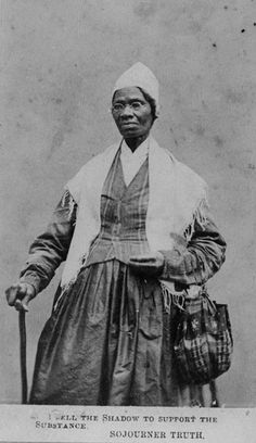 an old black and white photo of a woman holding a cane