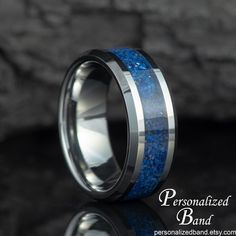 Introducing our stunning Personalized Lapis Lazuli Tungsten Wedding Ring for Man! This unique men's band features a mesmerizing blue lapis lazuli stone, symbolizing strength and truth. Each ring can be custom engraved with a special message, making it the perfect promise ring for him or a heartfelt gift for dad or husband. Crafted with durable tungsten, this ring is both stylish and long-lasting. Make your special moments even more memorable with this Details * 8mm width * Lapis Lazuli Inlay * Beveled edge * Comfort-fit * Grey * Hypoallergenic - Cobalt free * Pattern can vary Adding Personalization * All our rings can be laser engraved with your personalized messages. * Write your message in the "Add your personalization (optional)" section under the "RING SIZE/COLOR" drop down menu or in Wedding Ring For Man, Promise Ring For Him, Promise Rings For Him, Ring For Man, Promise Rings For Guys, Tungsten Mens Rings, Tungsten Wedding Rings, Jewellery Marketing, Blue Lapis Lazuli