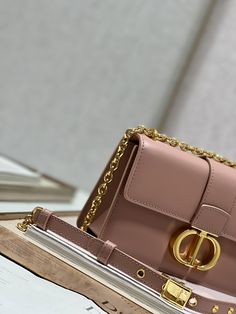 Crafted in smooth apricot calfskin, the timeless and elegant design elevates the collection. The flap is decorated with a metal CD clasp with antiqued gold finish, inspired by the closure of a Christian Dior perfume bottle. Additional details such as the 30 MONTAIGNE embossed logo on the back accentuate the clean design. With a detachable chain shoulder strap decorated with leather panels, it can be carried by hand, over the shoulder or cross-body. p128 Flip closure CD buckle 30 MONTAIGNE emboss Classic Gold Bag With Turn-lock Closure, Luxury Brown Flap Bag, Gold Shoulder Bag With Cc Turnlock For Evening, Classic Gold Flap Bag With Chain Strap, Timeless Gold Flap Bag With Gold-tone Hardware, Gold Shoulder Bag With Cc Turnlock Closure For Evening, Elegant Gold Flap Bag, Elegant Gold Flap Bag With Chain Strap, Elegant Brown Flap Bag With Branded Hardware