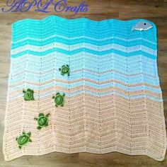 a crocheted blanket with turtle shells on the bottom and waves in the middle