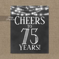 cheers to 80 years chalkboard sign with string lights on the side and white lettering