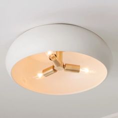 a white ceiling light with three lights on it's side and one is turned on