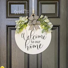 a welcome sign hanging on the front door