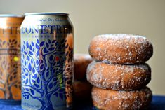 three donuts stacked on top of each other next to a can of liquid